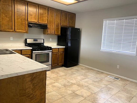 Ample storage and new countertops and faucet in this dine-in kitchen
