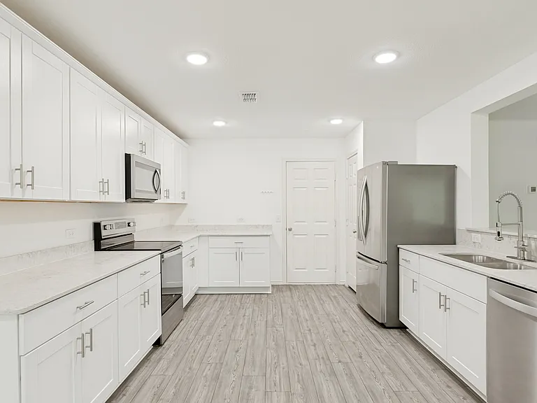 Includes refrigerator, quartz counters and white caninetry.