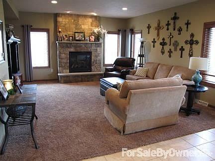 Living Room : Main living room with beautiful stone fireplace open to kitchen