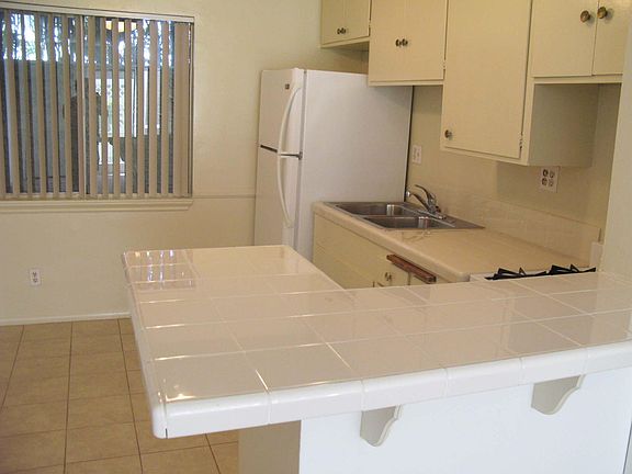Nice tile on counters and floor in kitchen.