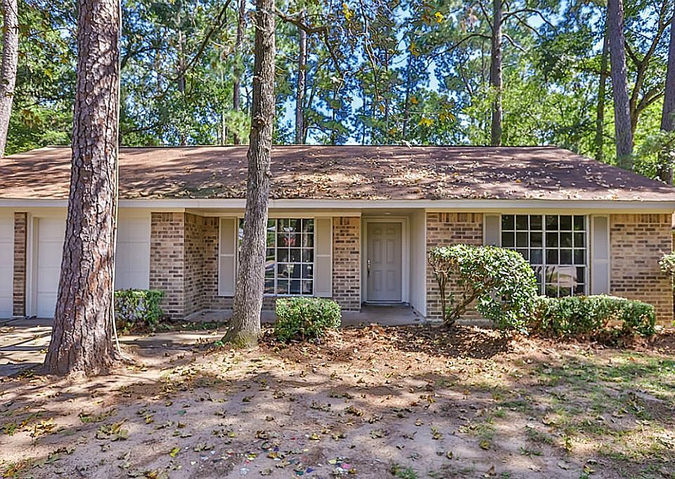 Welcoming front of the building featuring several mature trees. Gravel has been added since these pictures to provide 8 parking spaces.