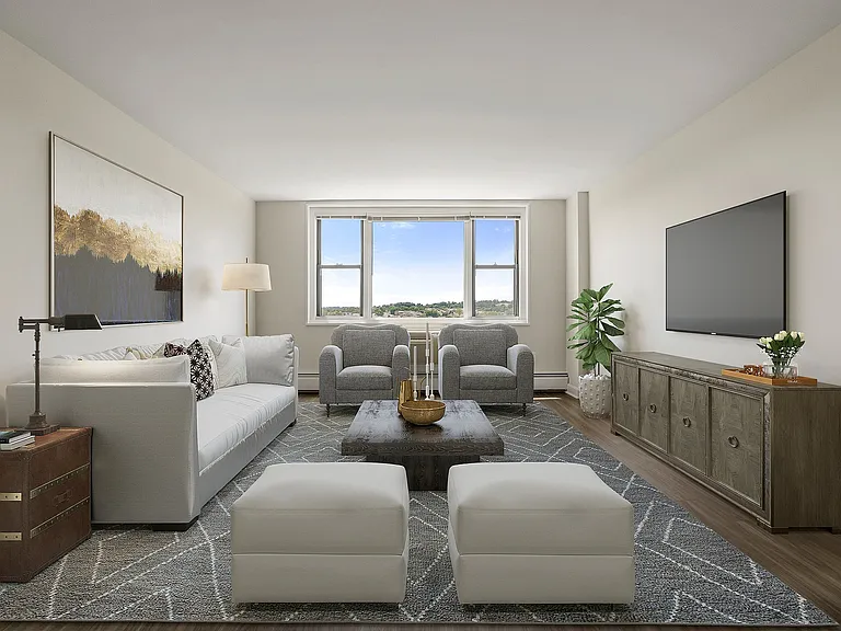 Elegant living room with plush grey sofa, modern armchairs, and expansive windows offering scenic views. Stylish decor and ample natural light create a welcoming atmosphere at Parkside Place, apartments in Cambridge, MA