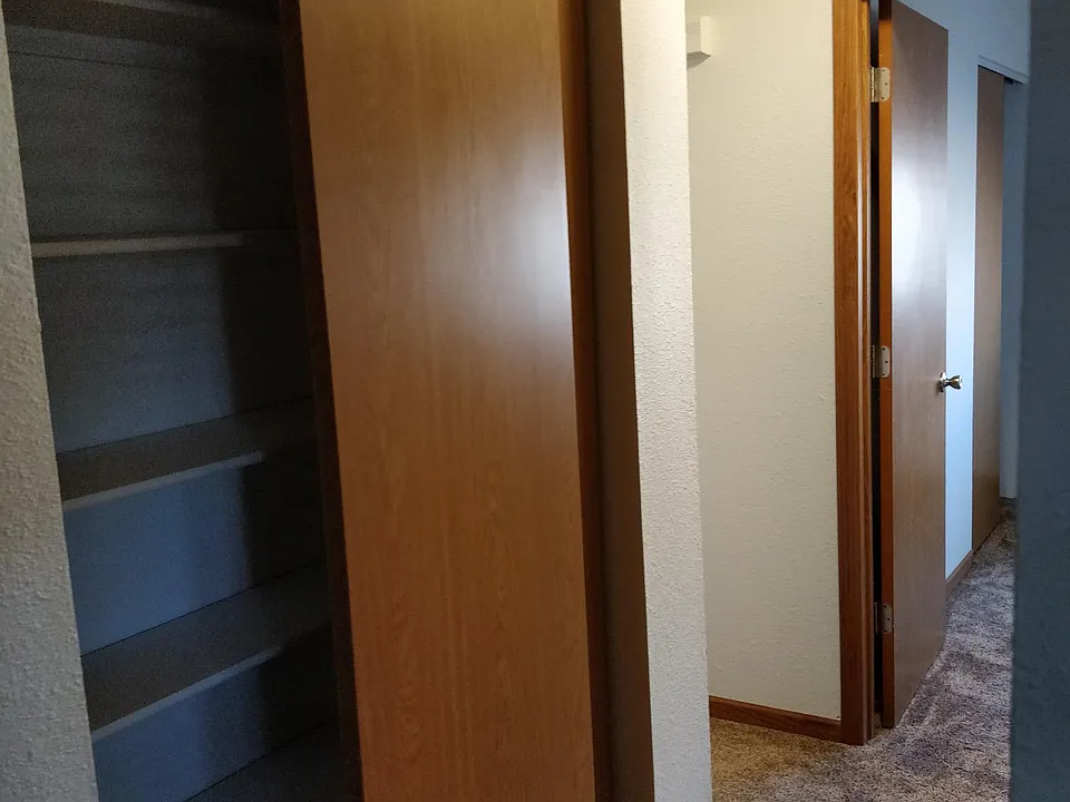 Hallway from living room to bed/bathroom with closet LEFT.