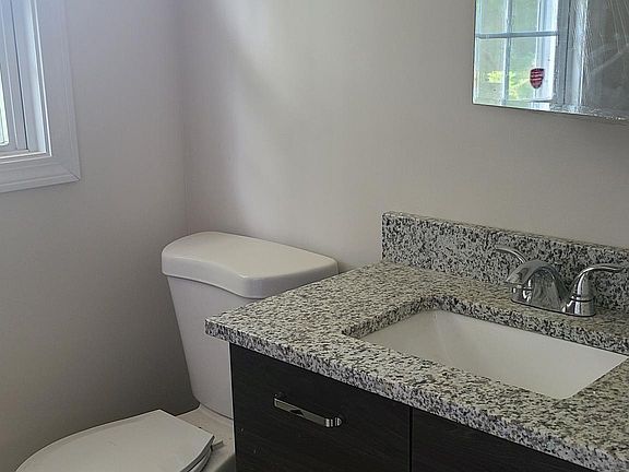 1st floor full bathroom with a walk in shower