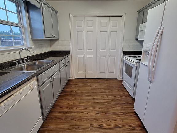 Galley Kitchen complete with Oven, Fridge, Microwave, Dishwasher, & Garbage Disposal