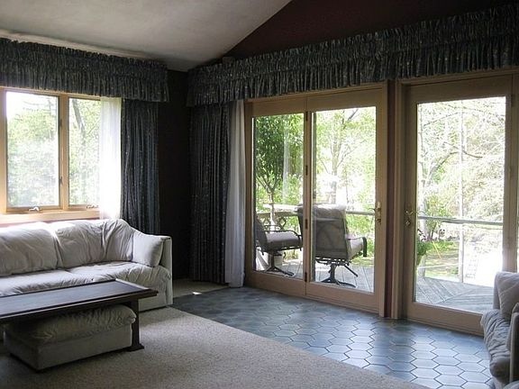 Living Room to deck overlooks the property to the lake