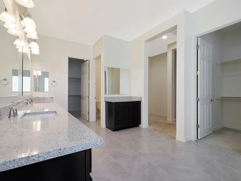 Primary bathroom. Double sinks, tub, shower, and two closets.