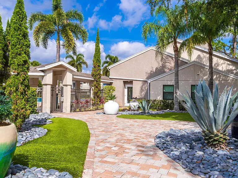 Step into serenity at Harper Grand in Orlando, FL. Our beautifully landscaped courtyard features tropical plants, modern pavers, and vibrant pottery for a tranquil welcome.