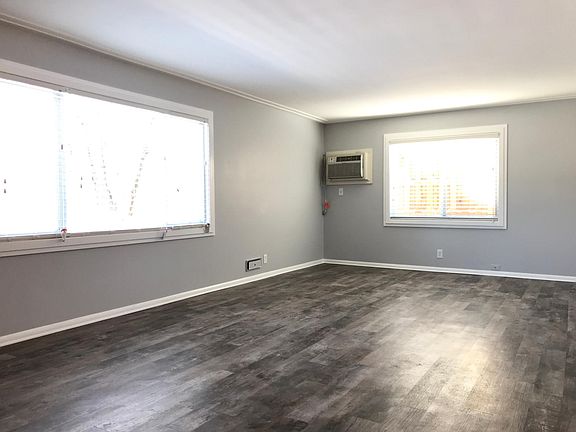 Large living room with view of park, great natural light.