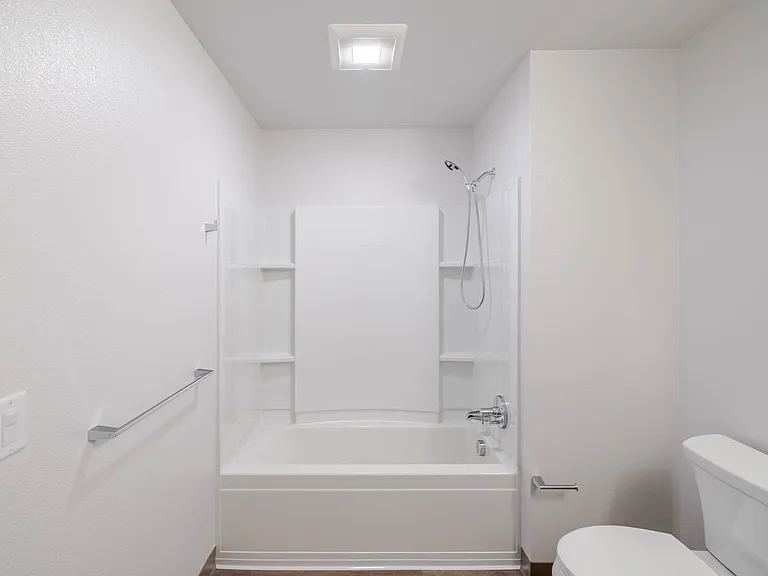 Bathroom A with a full-sized bathtub and simple design.