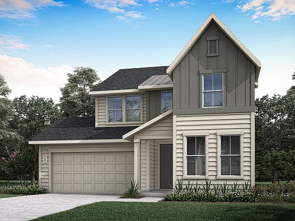 A two-story house with a gabled roof, gray siding, and a garage door stands in a landscaped yard sur