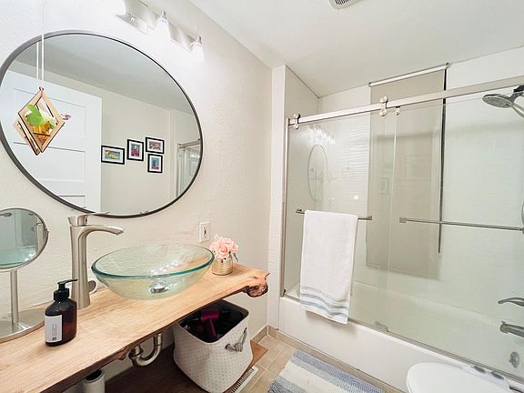 Renovated modern bathroom with a closet behind the door