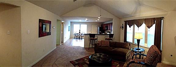 Wow! What a spacious open floor plan. Note the vaulted ceiling, bright windows, homey fireplace! Jus