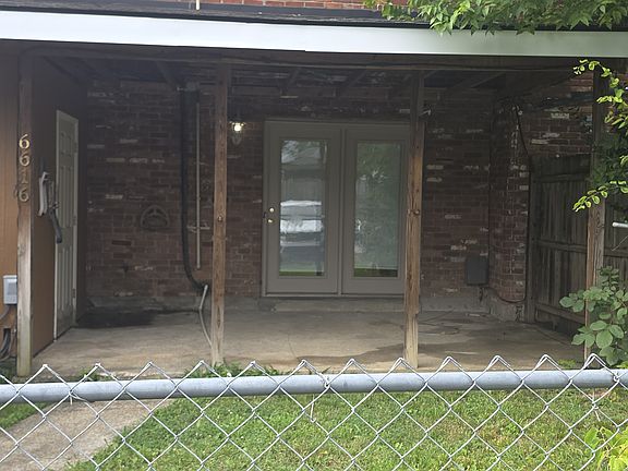 Back of townhouse with covered patio and fenced yard
