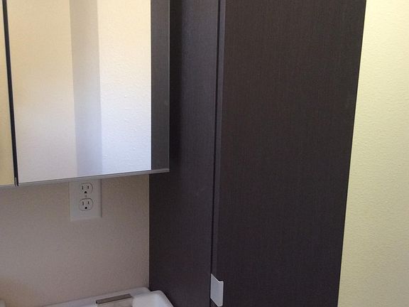 Ikea sink, medicine cabinet, and extra storage cabinet with power inside.