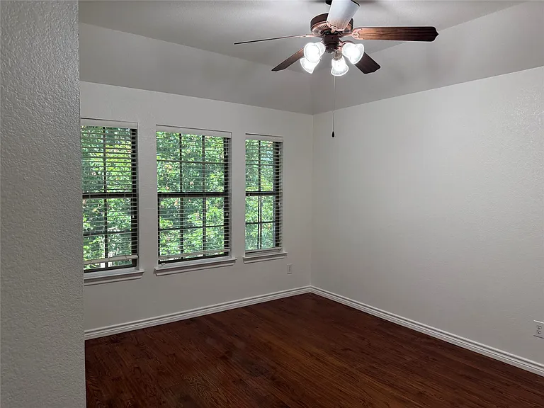 Secondary bedroom #3 with a view to the street and greenbelt.