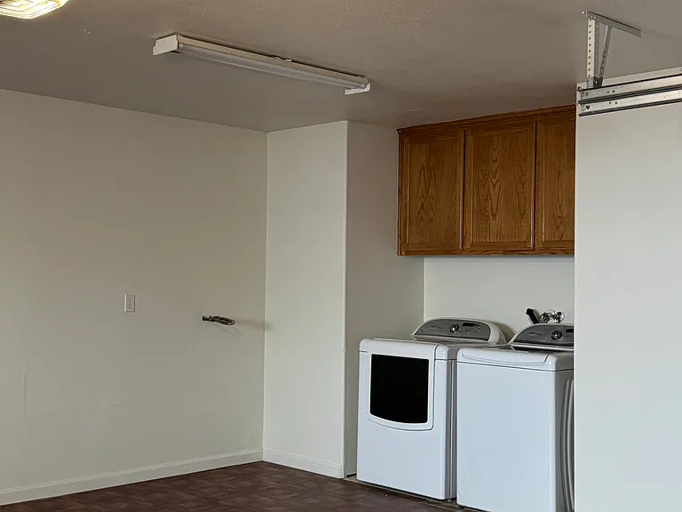 Washer and Dryer with Storage Cabinet in 20' x 23' Garage