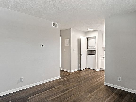 Step into a contemporary living space with chic floors and convenient laundry amenities.