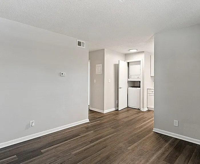 Step into a contemporary living space with chic floors and convenient laundry amenities.