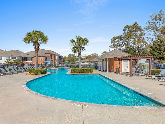 Cool off in the resort-style pool and relax in the lounge area at The Quarters, student apartments near UL Lafayette.