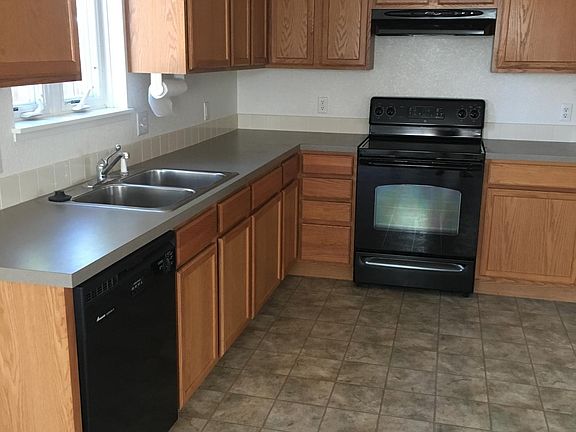 Large kitchen with spacious cupboards, dishwasher, range and refrigerator with icemaker and water in the door.