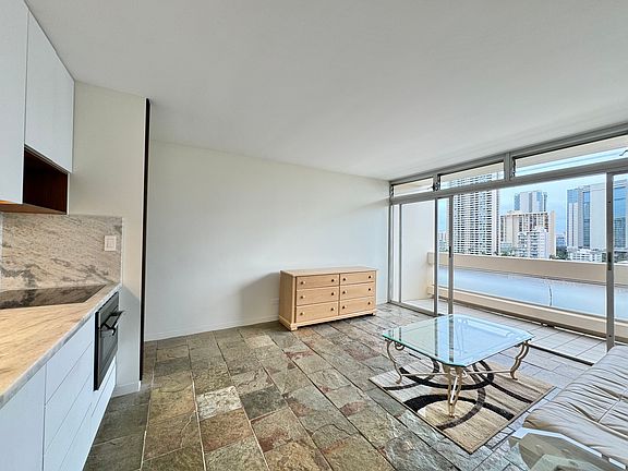 Living room from the kitchen side: cool tiled floors and smooth ceiling