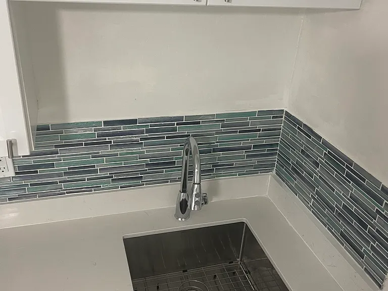 12 inches deep sink. Luxury faucet on a quartz countertop