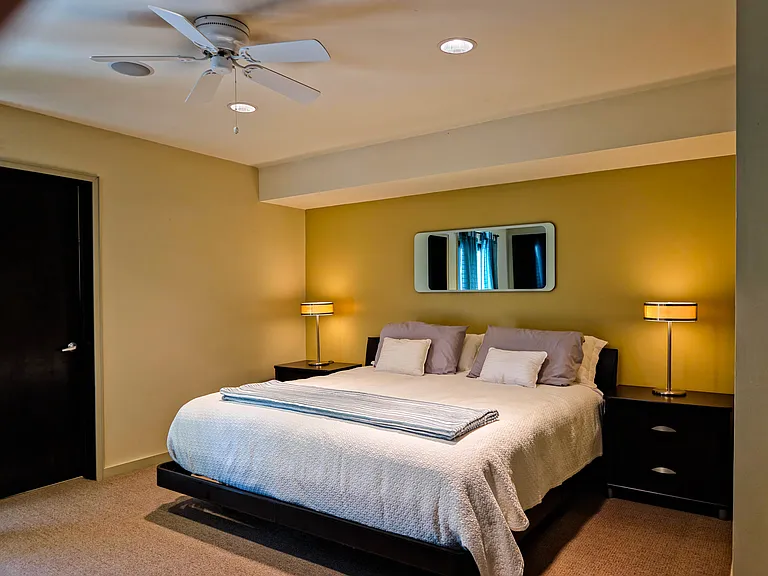 Primary bedroom with king sized bed and bedside tables.