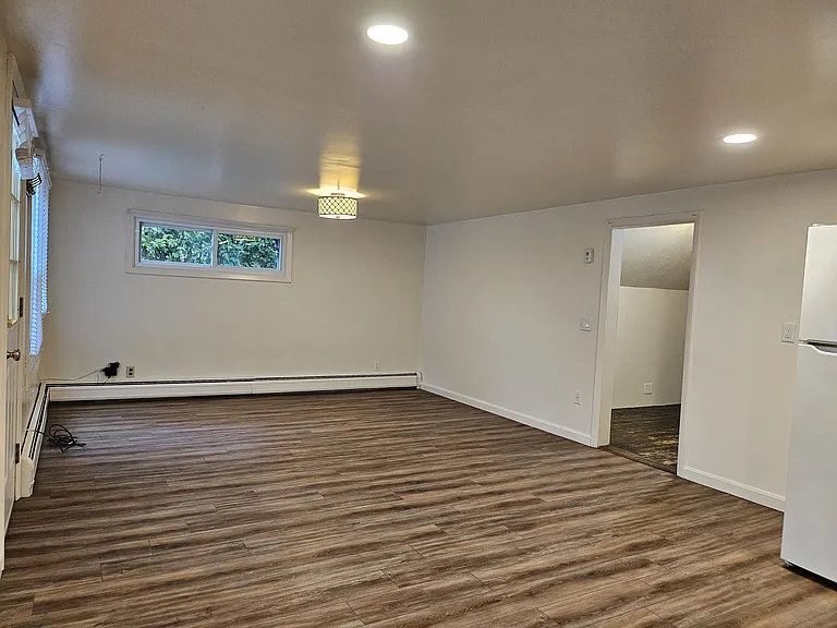 The living room is open to the kitchen, yet offers enough space for a sofa, chairs and TV.