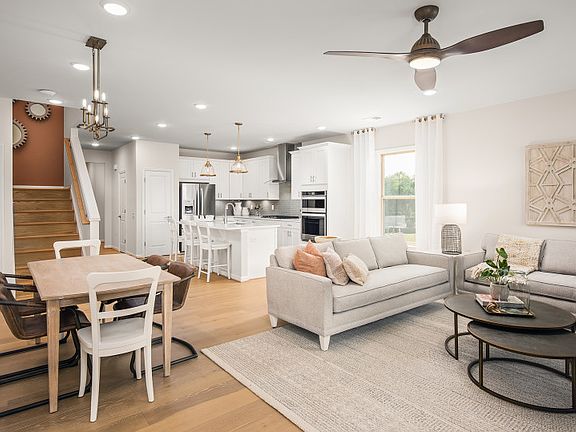 Open Home Design Featuring Hardwood Floors and Oak Stairs