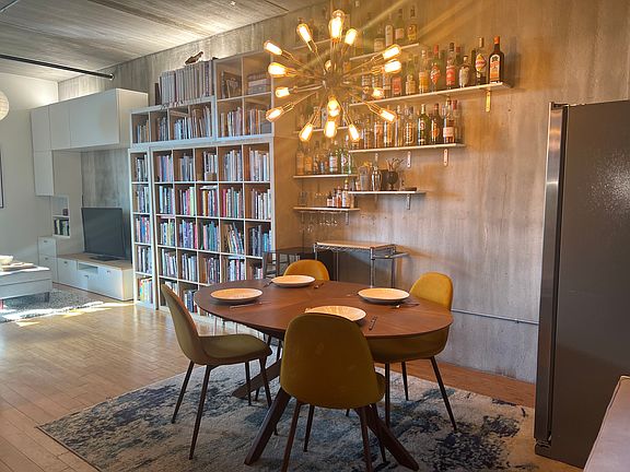 Dining area with built in shelves to create a bar area