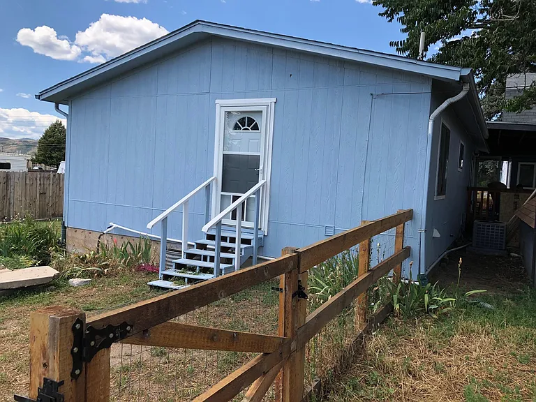 East back door with fenced-in yard.