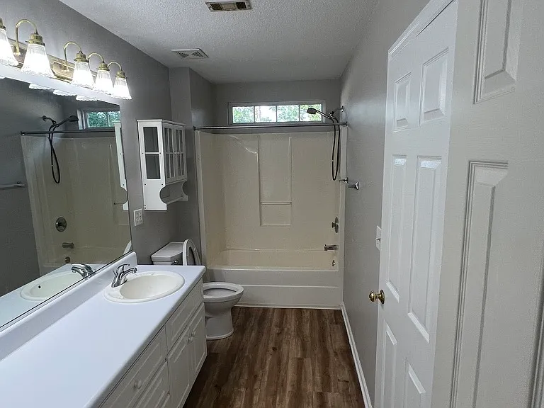 Master bathroom with two sinks, full tub/shower and linen/storage closet