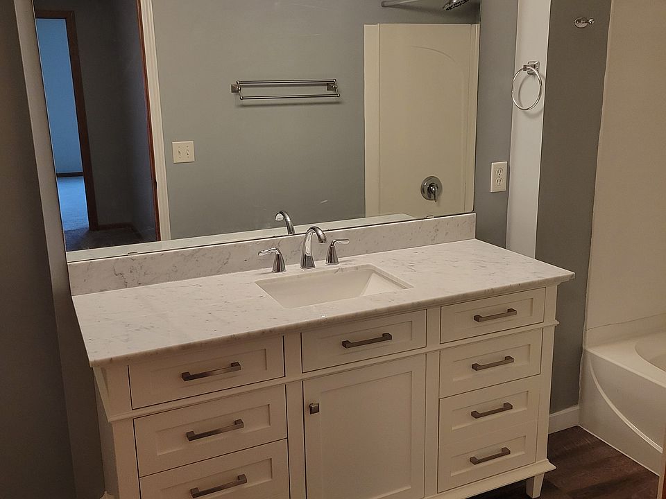 Remodeled upstairs bathroom with new vanity, flooring and lighting