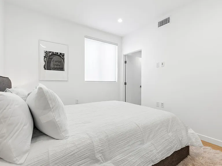 Upstairs guest bedroom with a clean and minimalistic design.