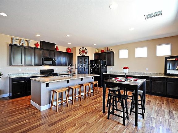 Kitchen with granite counters, walk in pantry with lots of cupboards.