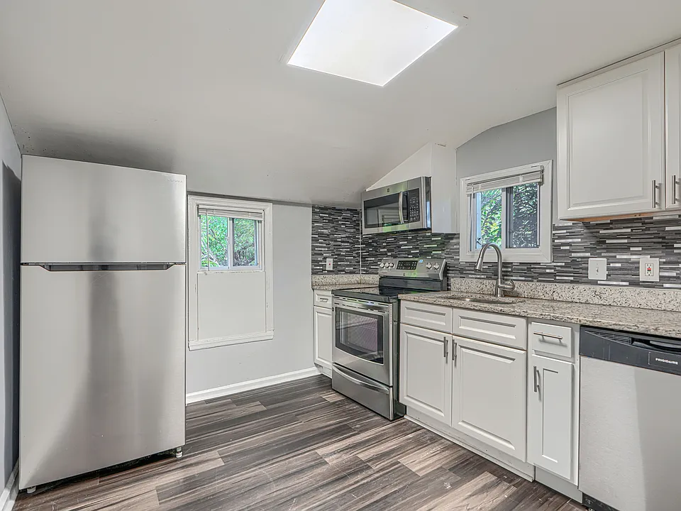 Enter into the spacious eat-in kitchen with stainless steel appliances and granite countertops.
