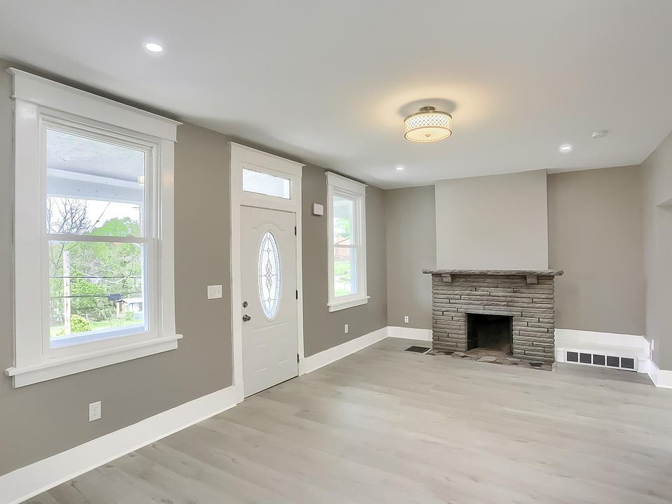 Welcome to 2041 Woodward Ave! This lovely 3 bedroom 1 and 1/2 bath home has been redone on the interior to the studs! New electric,new plumbing,new flooring new kitchen cabinets and stainless steel appliances! Here is the large livingroom. Notice the ston