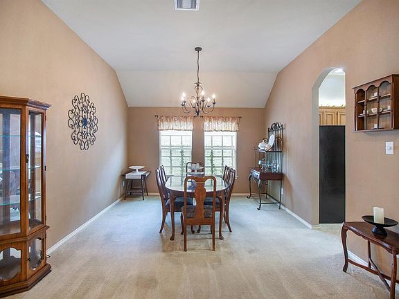 Formal dining room includes a lovely light fixture and direct access to the kitchen.