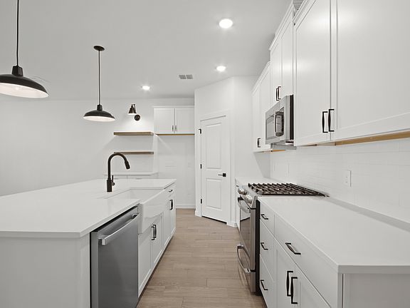 Kitchen with pendant lighting floating shelves