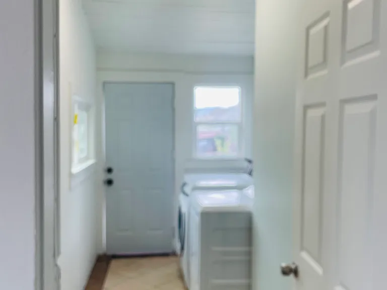 Laundry room and a door to the backyard