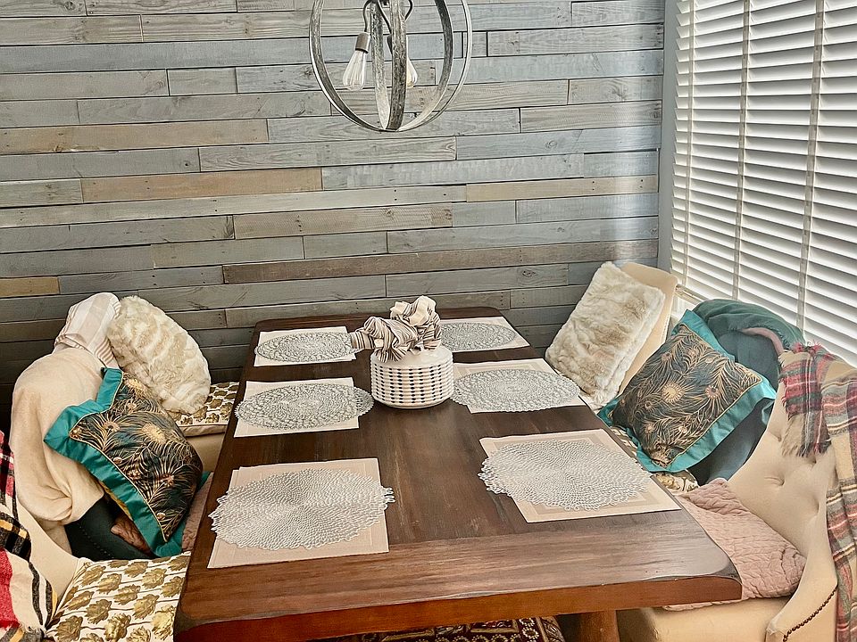 Dining Area with Large Window, Chandelier and Accent Wall