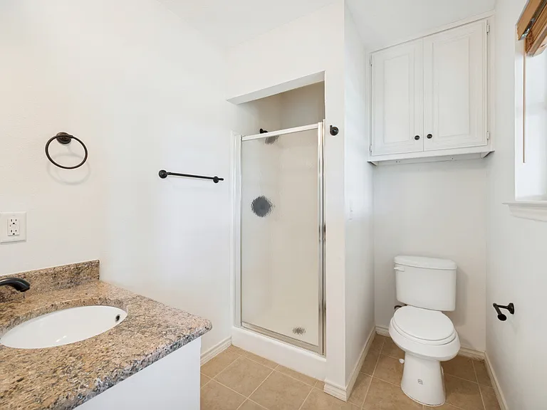 Guest bathroom with shower off the family room and inside patio door.