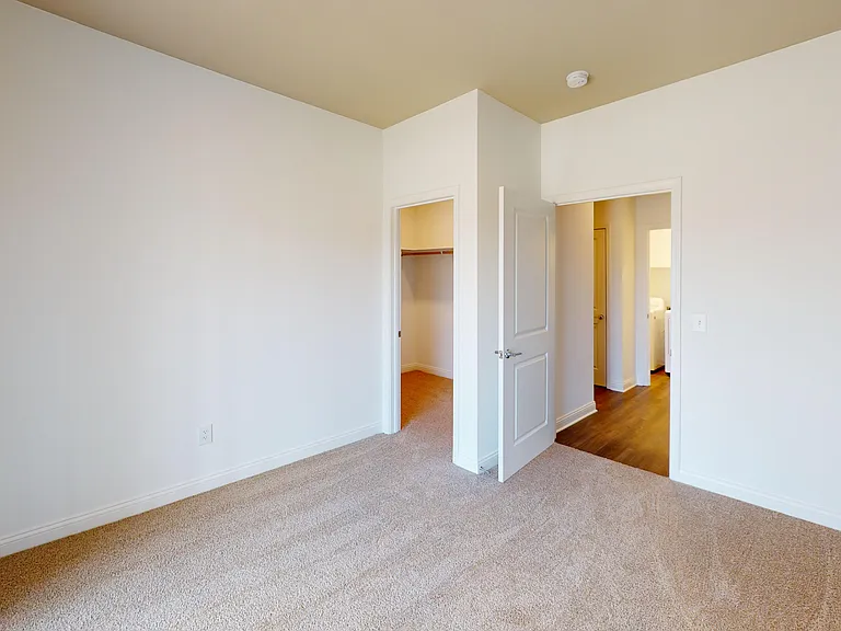 The Pyle floor plan bedroom features plush carpeting and a walk-in closet. The Pyle floor plan bedroom features plush carpeting and a walk-in closet.