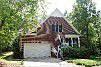 Side load 2 car garage and view of screen porch