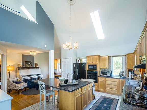 Kitchen - pictured oversized L shaped island which fits 5-6 people comfortably at the dining table