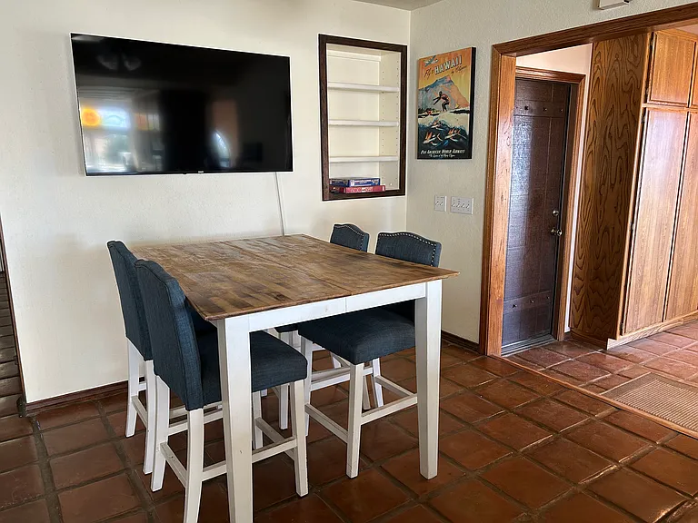 Kitchen area is so large that it includes a bar-high table. Watch your favorite TV program while you cook! To the right is the enclosed patio and door to the garage.