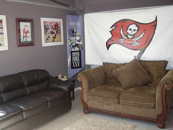 garage with tv and furniture- all included with house