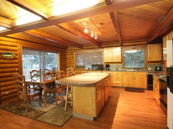 Center island seperates the kitchen from the dining area. Sliding glass doors lead to the back yard deck with a stunning view of the lake.