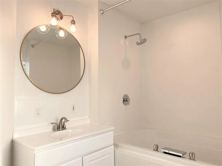 Large full bath with soaking tub and shower on main floor.